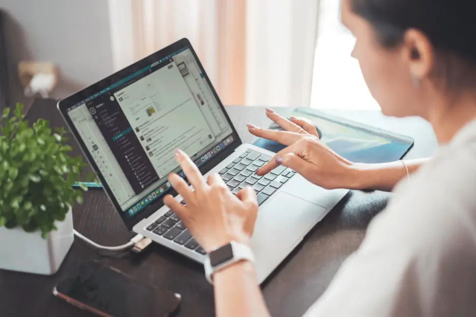 Software support professional working on a laptop providing Zlendo Realty AI onboarding and training assistance