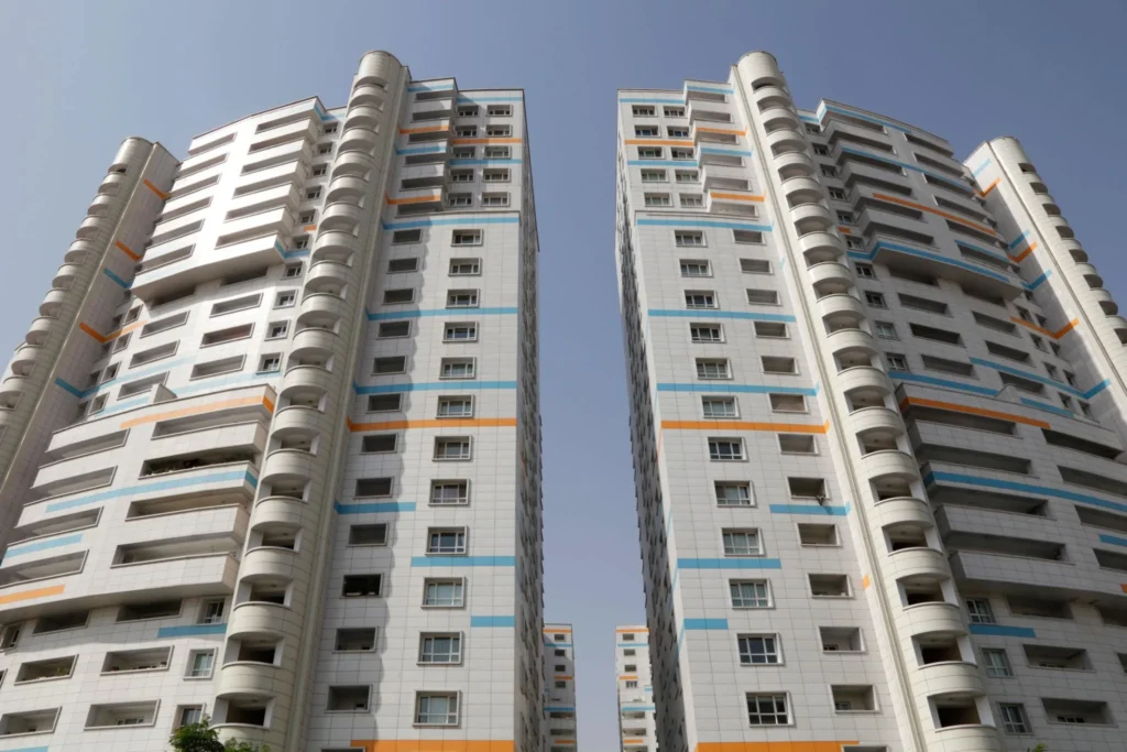 High-rise residential apartment towers featuring modern architecture, multi-story housing units, balconies, and efficient urban residential building design in a city environment.